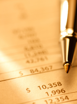 A financial report symbolized by a golden sheet and a golden pen